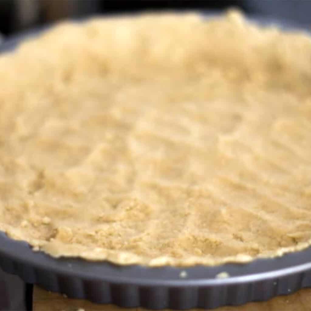 the dough pressed into the tart pan