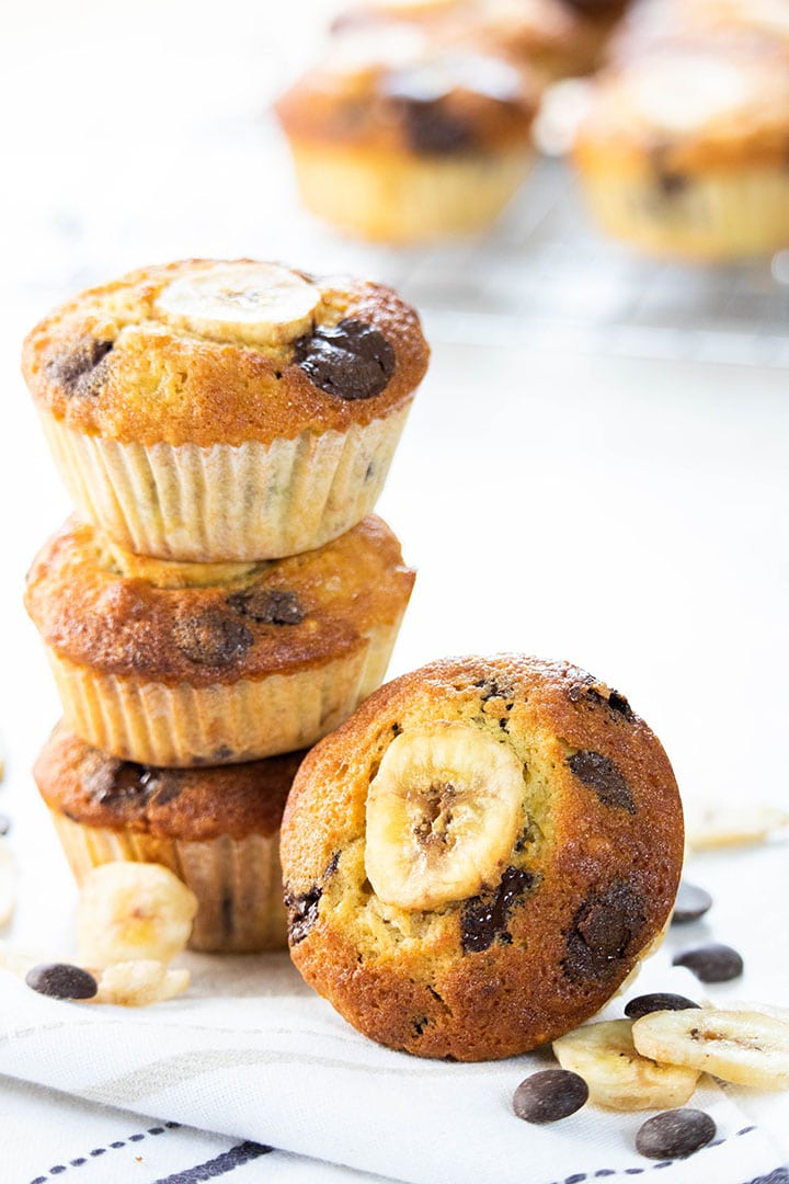 Banana Chocolate Chip Muffins stacked on top of each other with one facing forward