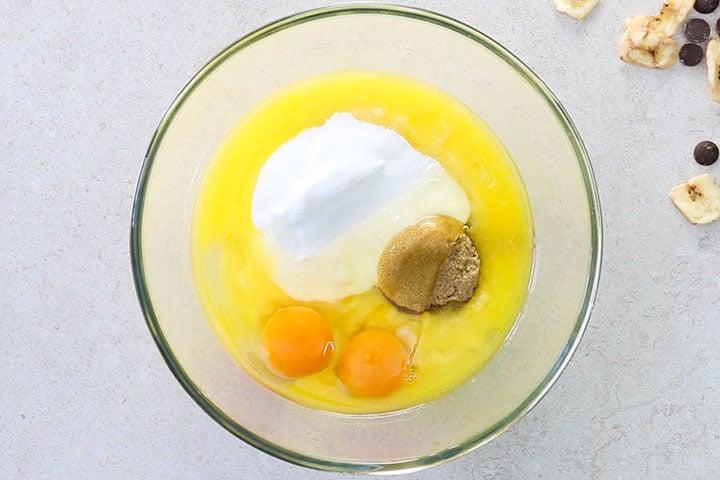 The sugars, vanilla and eggs added to the mixing bowl