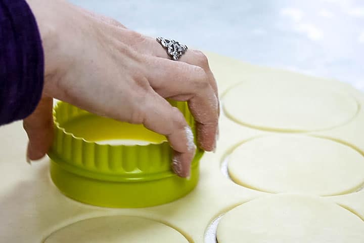 The dough being cut into circles