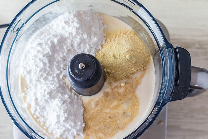 The whipped cream ingredients in a food processor ready to mix