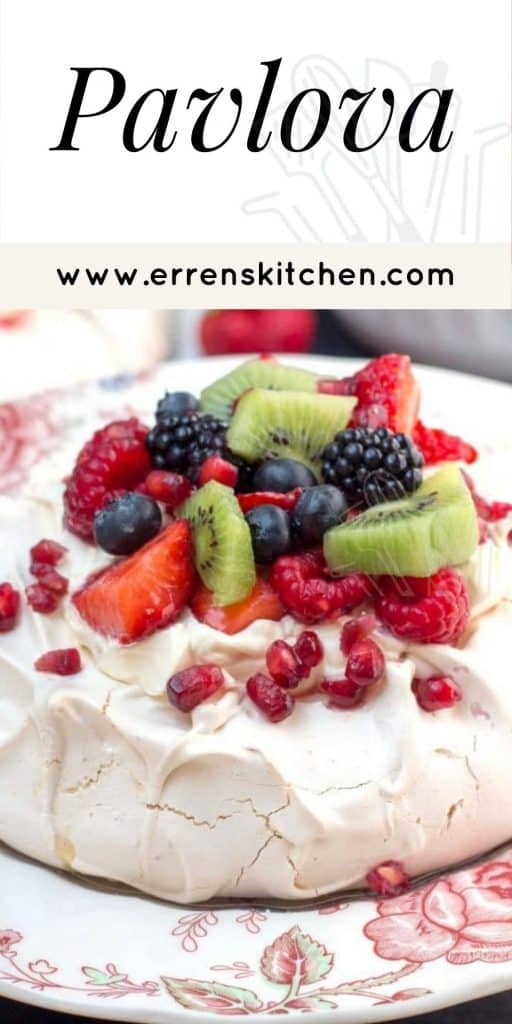 a pavlova covered in fruit, ready to eat