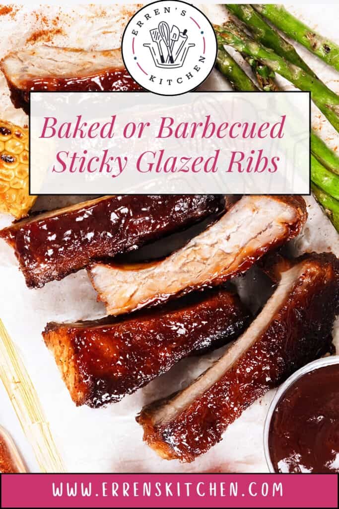 Close-up of Baked or Barbecued Sticky Glazed Ribs coated in shiny barbecue sauce, served with grilled asparagus and corn on the cob. Text overlay reads, “Baked or Barbecued Sticky Glazed Ribs.”.