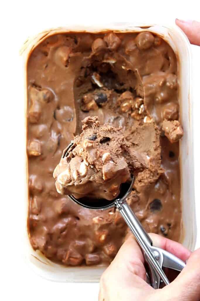 a scoop of Chocolate Marshmallow Ice cream over a full container