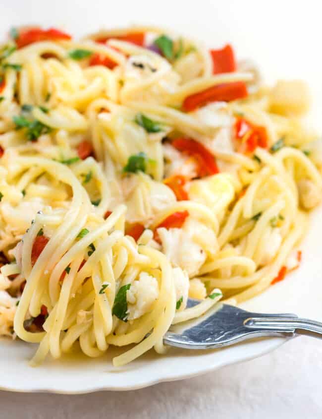 the Crab Pasta on a white plate with a fork twirling the spaghetti laying on the plate