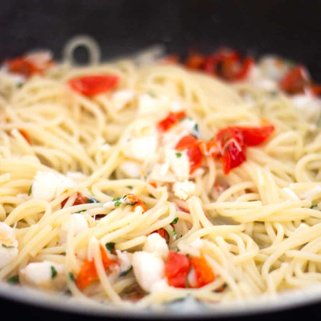 the pasta added to the pan with the sauce.