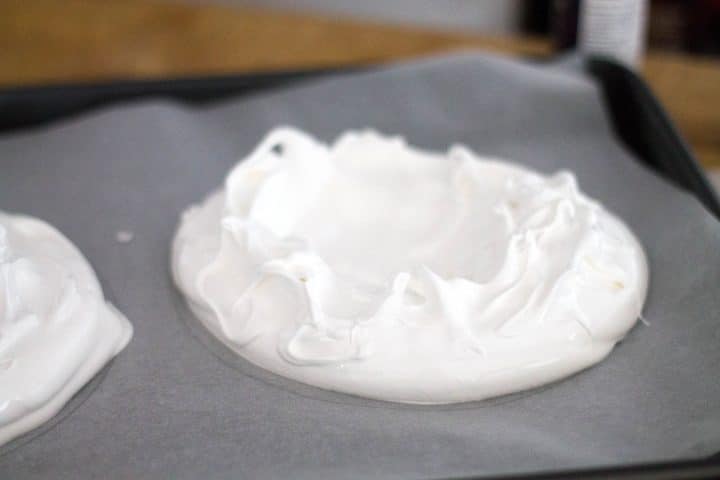 meringue spread onto the template on the baking sheet