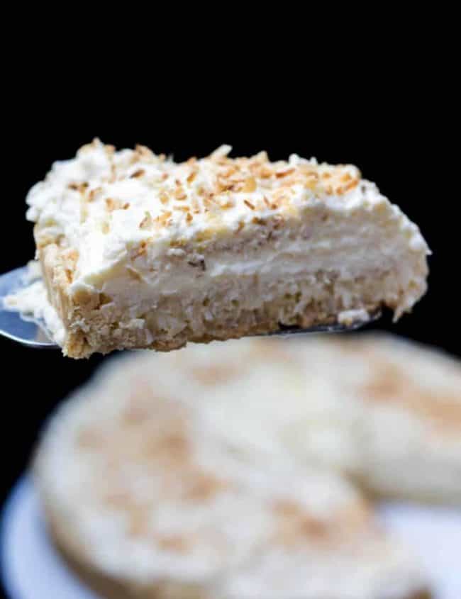 A piece of coconut cream pie on a cake slice