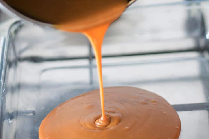 The sticky bun topping being poured into the baking pan