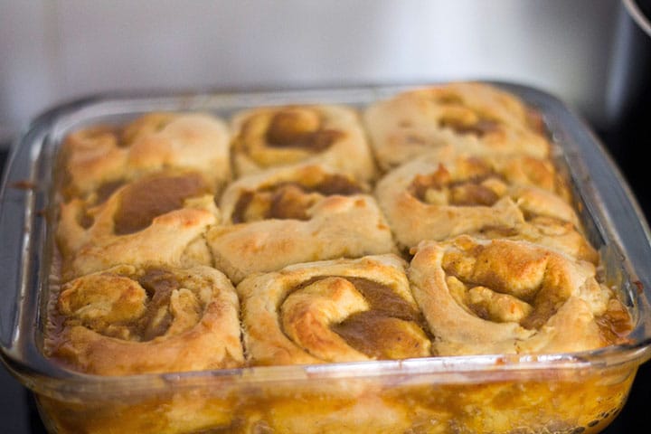 the rolled up filled dough in round in a pan