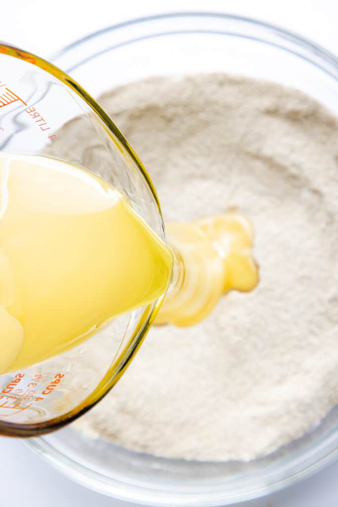 The wet ingredients being poured into the dry ingredients.