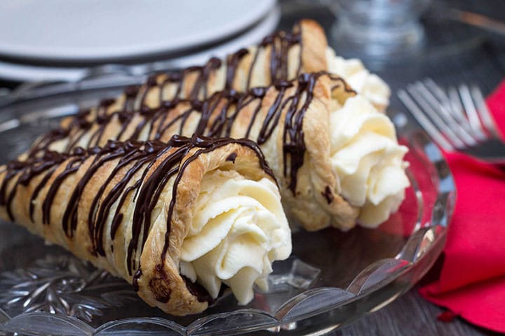 dark chocolate cream horns on a plate ready to serve