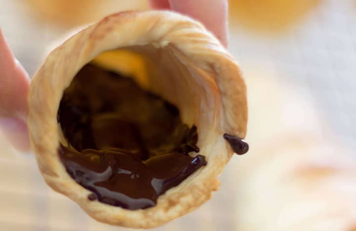 A close up of the pastry horn with melted chocolate spread into it.