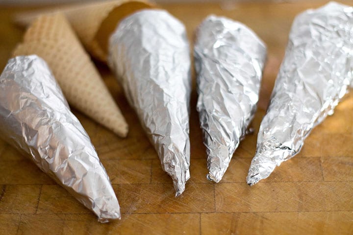 wafer ice cream cones wrapped in non stick foil with two ice cream cones unwrapped