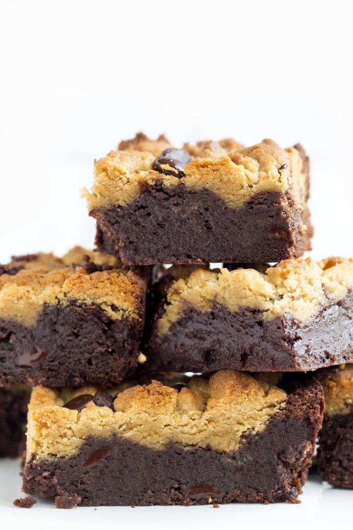 a close up of squares of peanut butter chocolate fudge brownies piled on top of each other