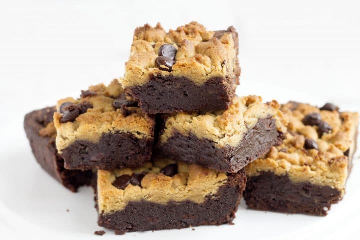 squares of peanut butter chocolate fudge brownies piled on top of each other