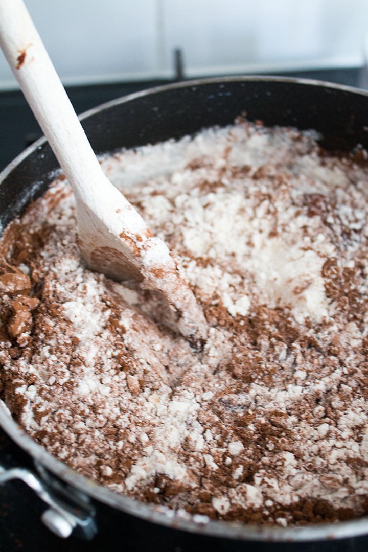 Flour mixture being added to the butter and chocolate mixture