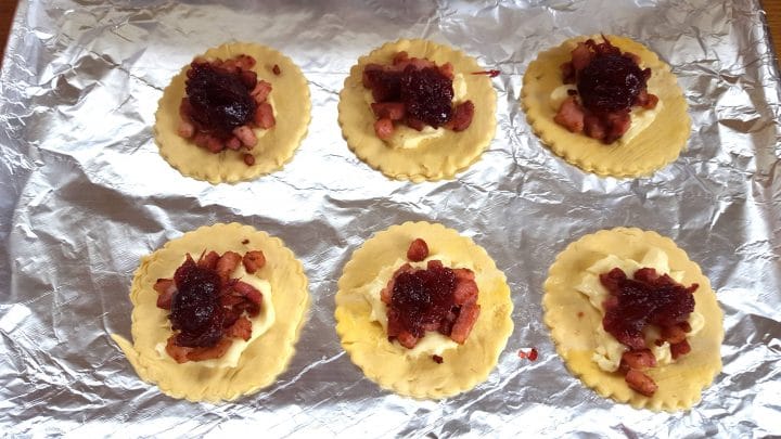The rounds on a baking tray topped with the stuffing