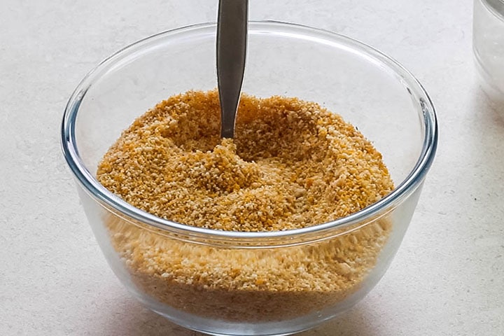 The breadcrumb mixture in a glass bowl