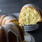 a slice of citrus olive oil cake drizzled with frosting