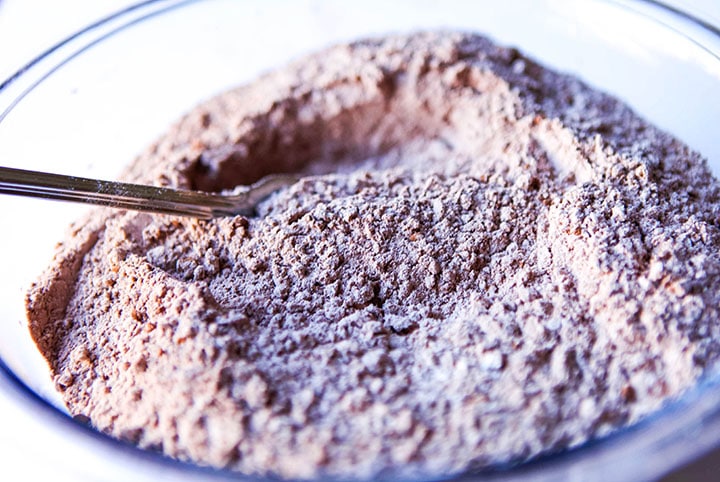 A bowl with flour, cocoa powder, sugar, salt,and baking powder mixed together
