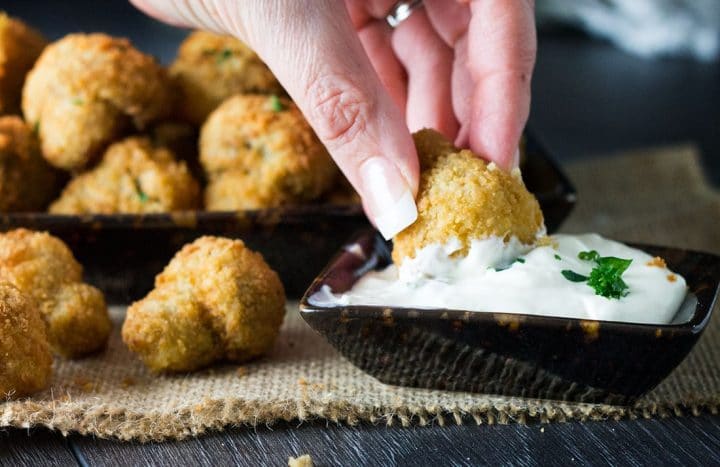 Baked Breaded Garlic Mushroom being dipped into a white dipping sauce
