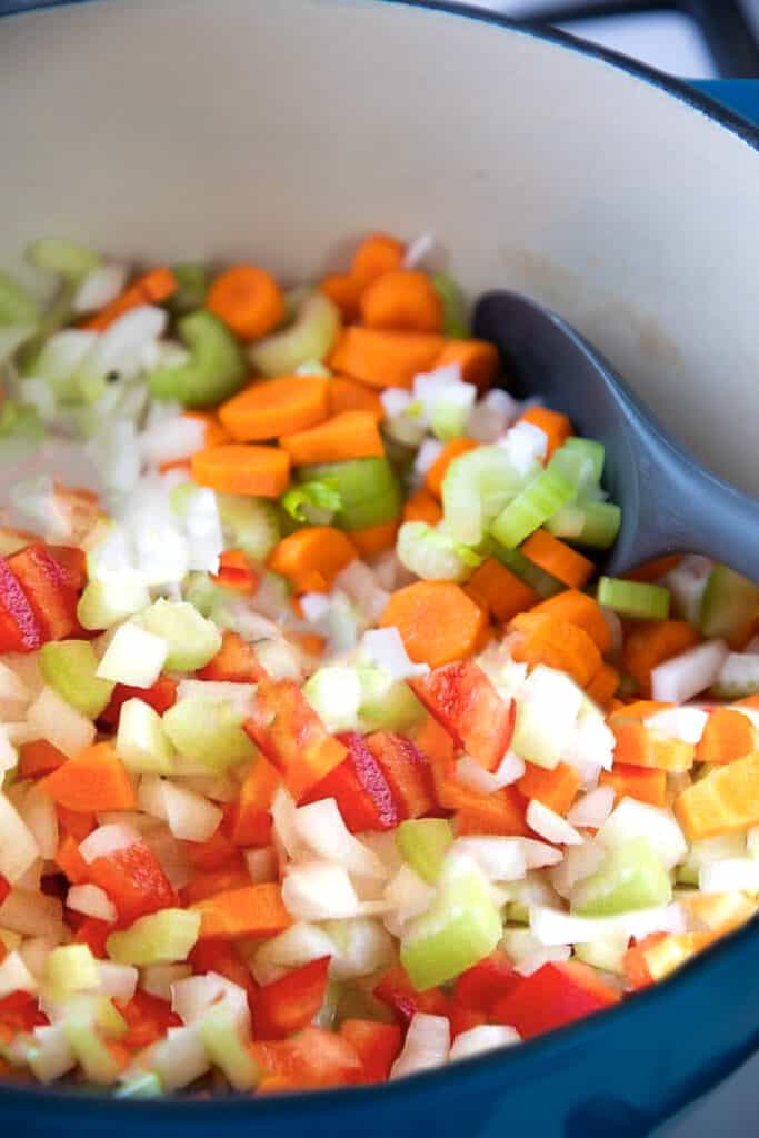 Onions, celery, peppers and carrots cooking in a pan