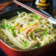 A bowl of Chinese noodle soup with chopsticks