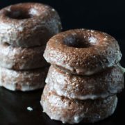 two piles of baked glazed chocolate donuts