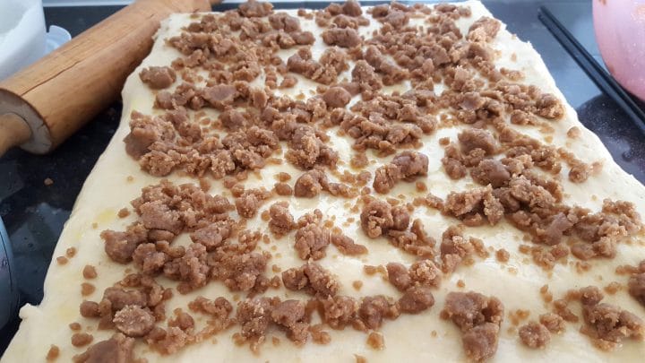 rolled out dough scattered with the crumb filling