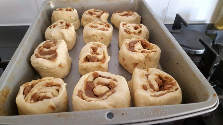 raw Cinnamon Crumb Buns in a pan ready for the second rise.