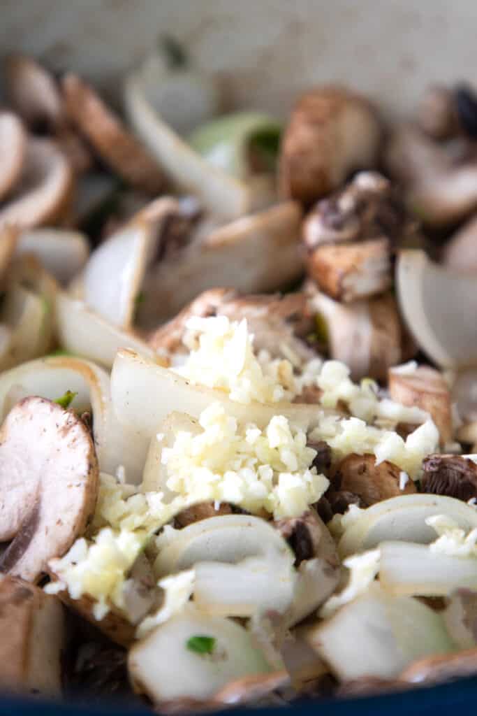 onions, mushrooms, anf garlic cooking in a pan