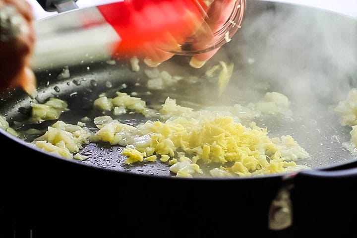 The ginger being added to the pan