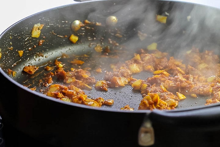 The spices cooking with the onion mixture