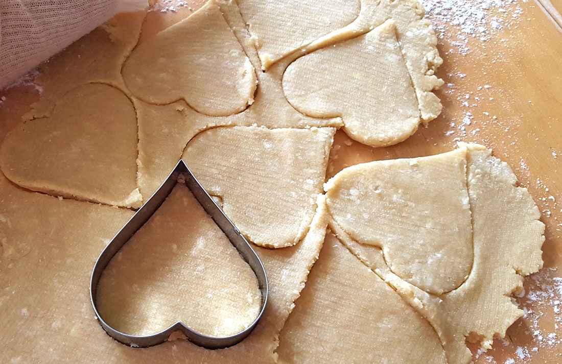 Cookie dough with heart shapes cut out