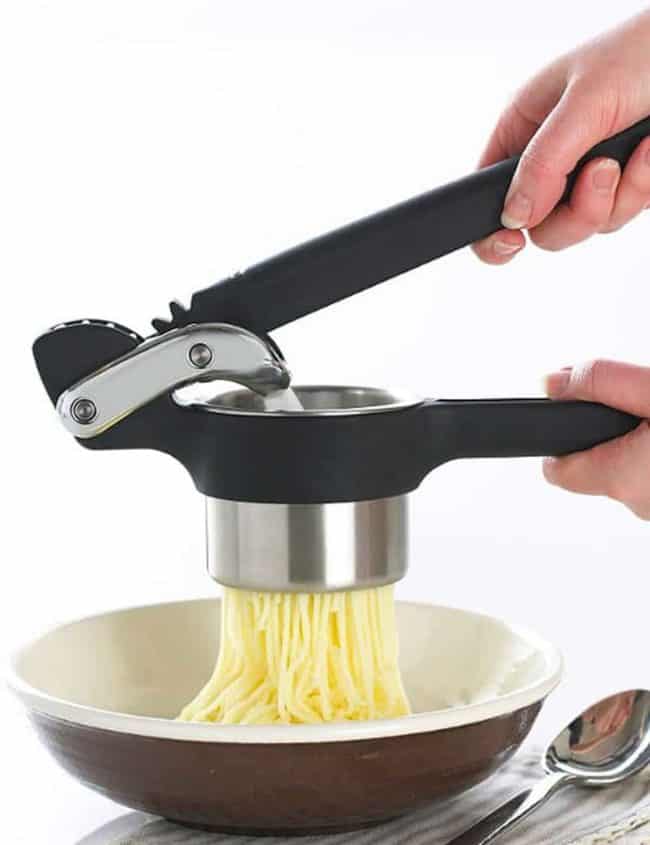 potatoes going through a potato ricer
