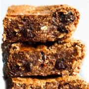 A close up of a stack of Oatmeal cookie bars with soft centers