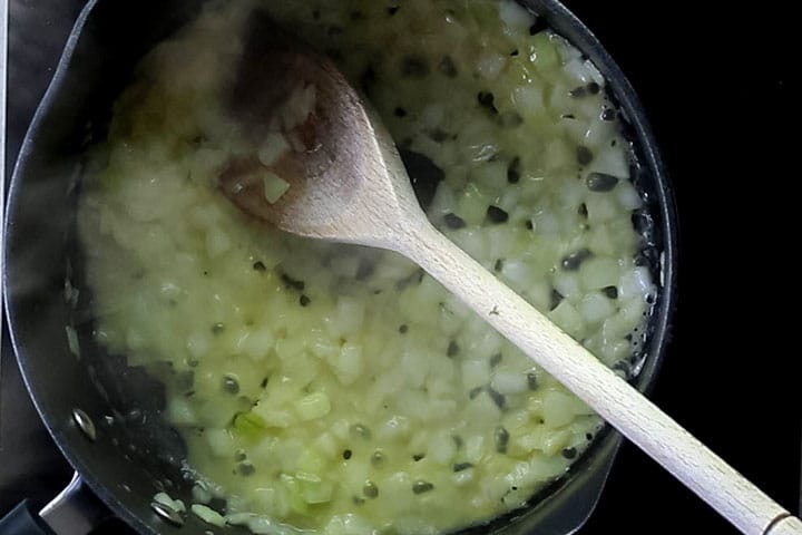 onions sauteing in a pan with butter