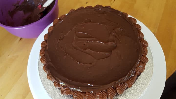 one half of a chocolate cake with frosting on the top