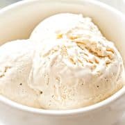 a close up of scopped vanilla ice cream in a bowl