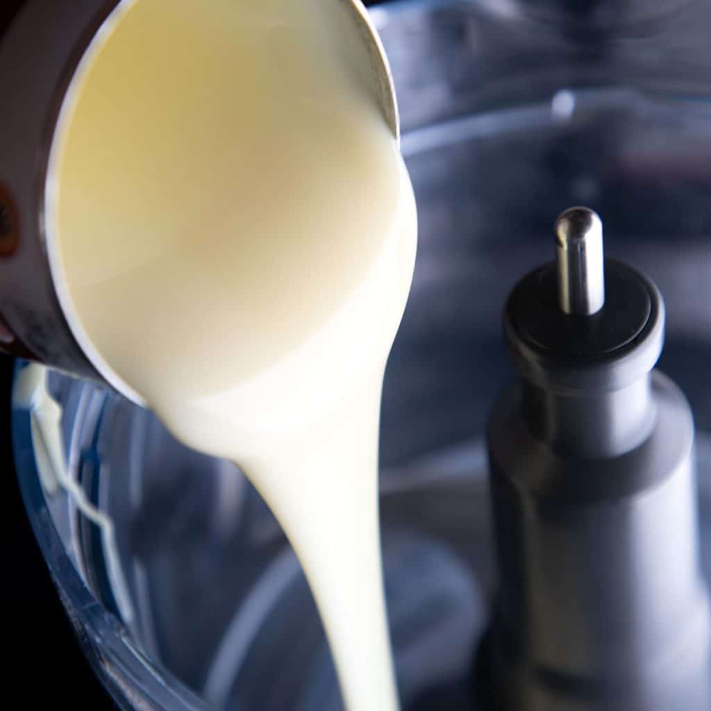 condenced milk being poured into a bowl