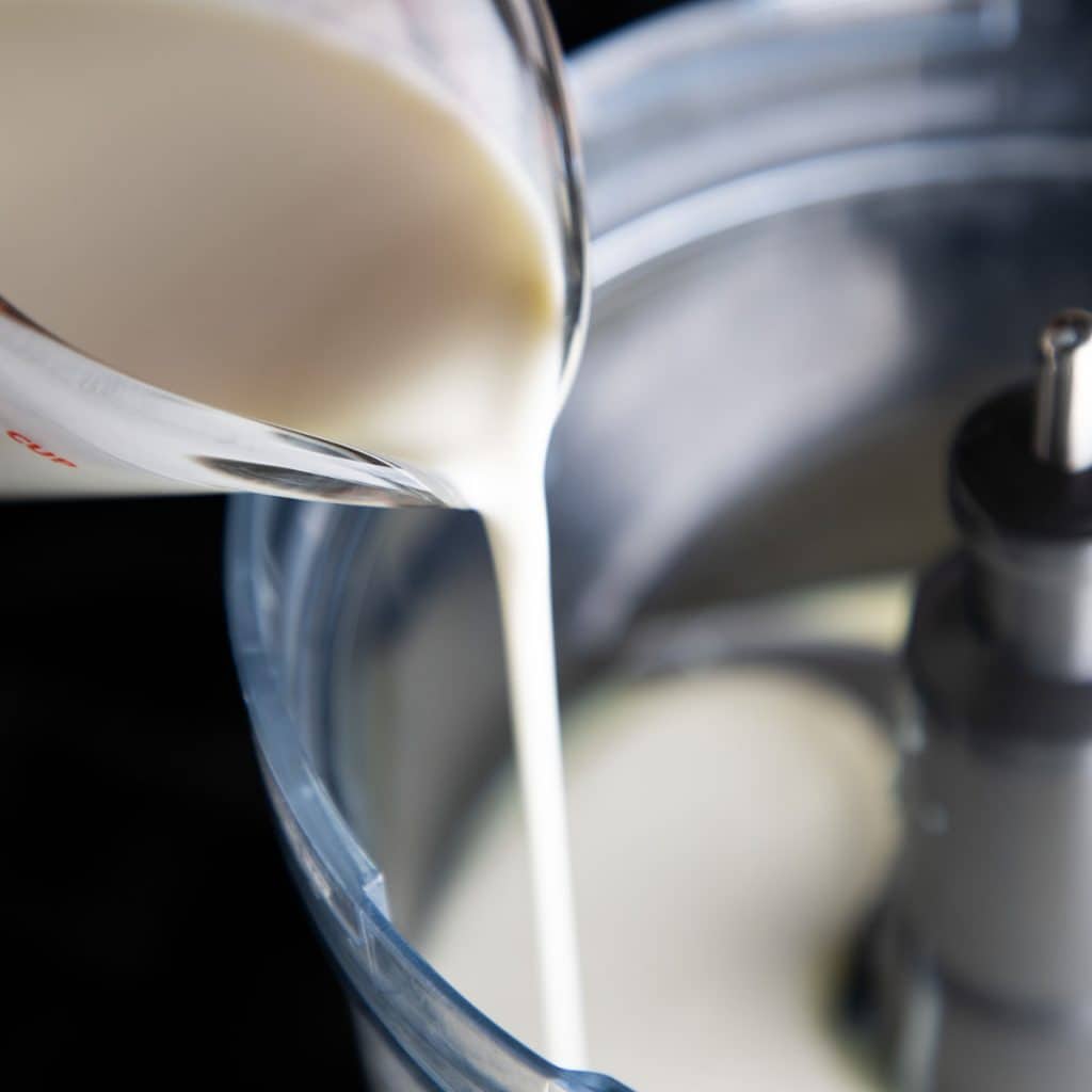 cream being poured into a bowl