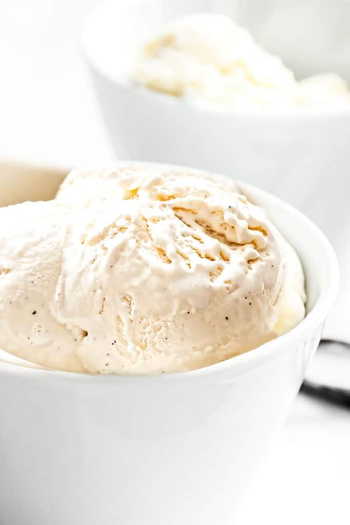 a bowl of scooped vanilla ice cream