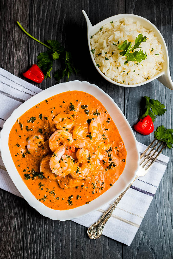 A plate Thai Red curry shot from above with rice and cutlery