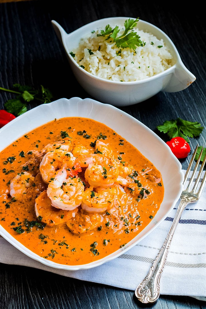 A bowl of red Thai curry with rice and cutlery