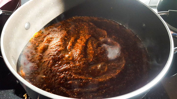 The curry paste cooking in a pan