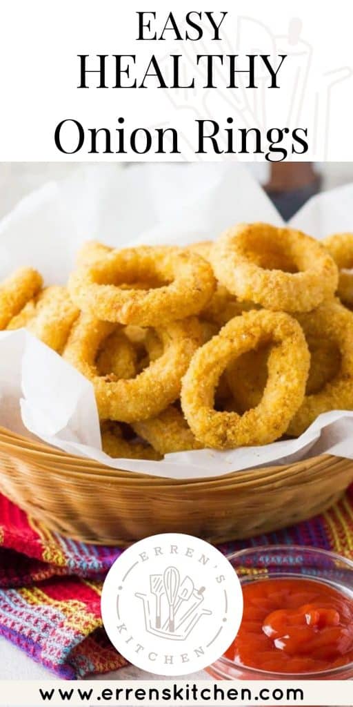 onion rings in a basket with a side of tomato sauce