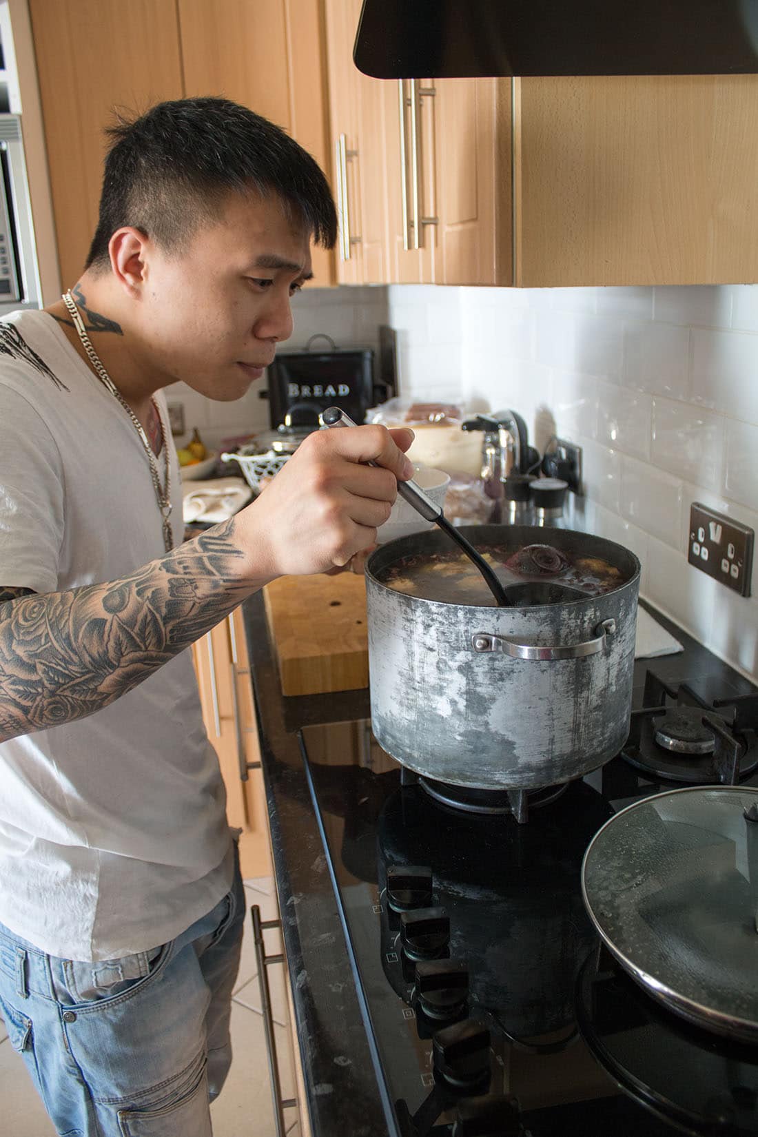 Tuan stirring the soup with a ladle