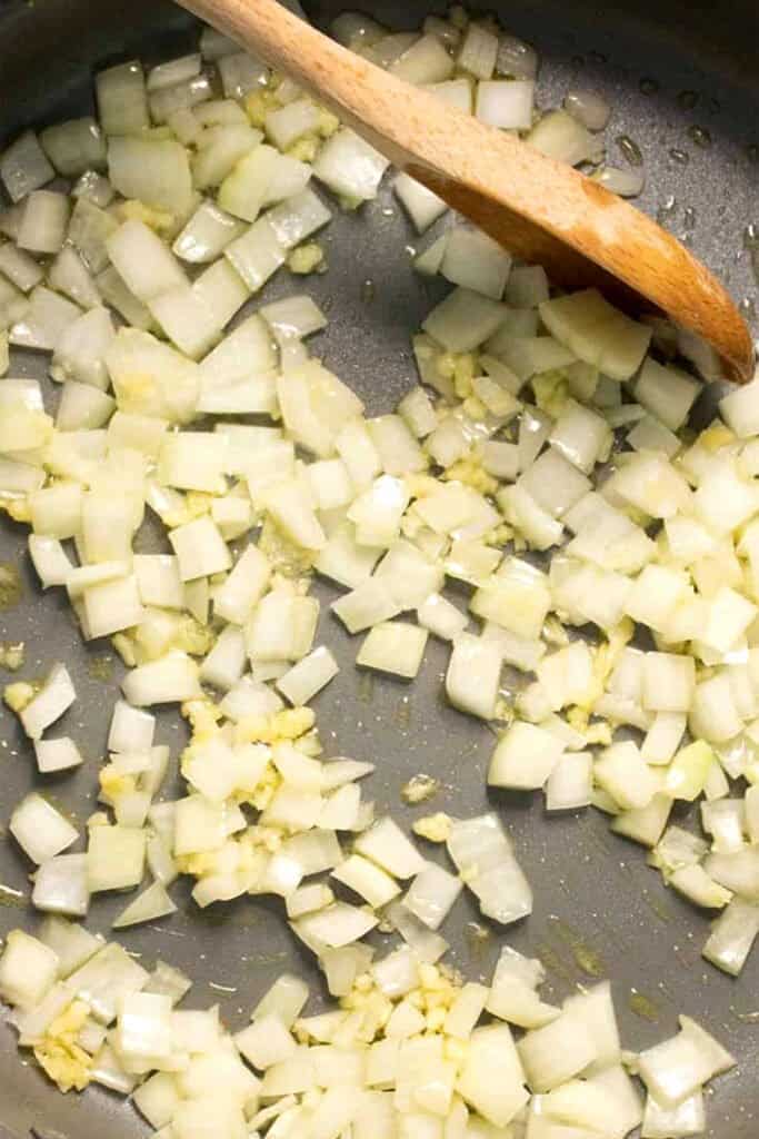 onions and garlic cooking in a pan