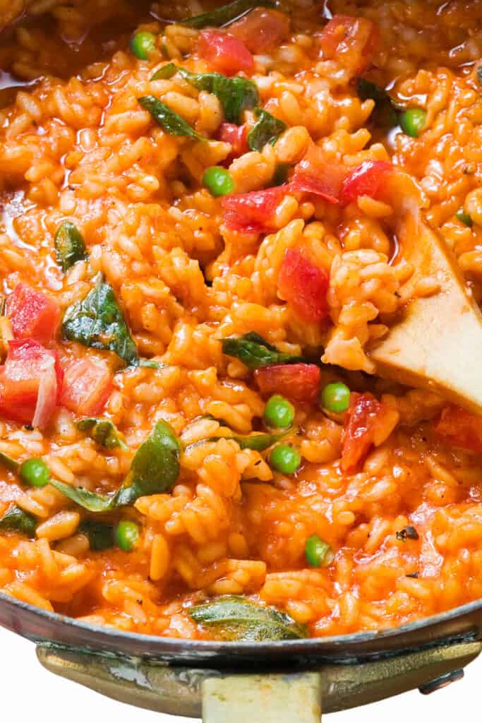 tomato risotto in a pan with peas